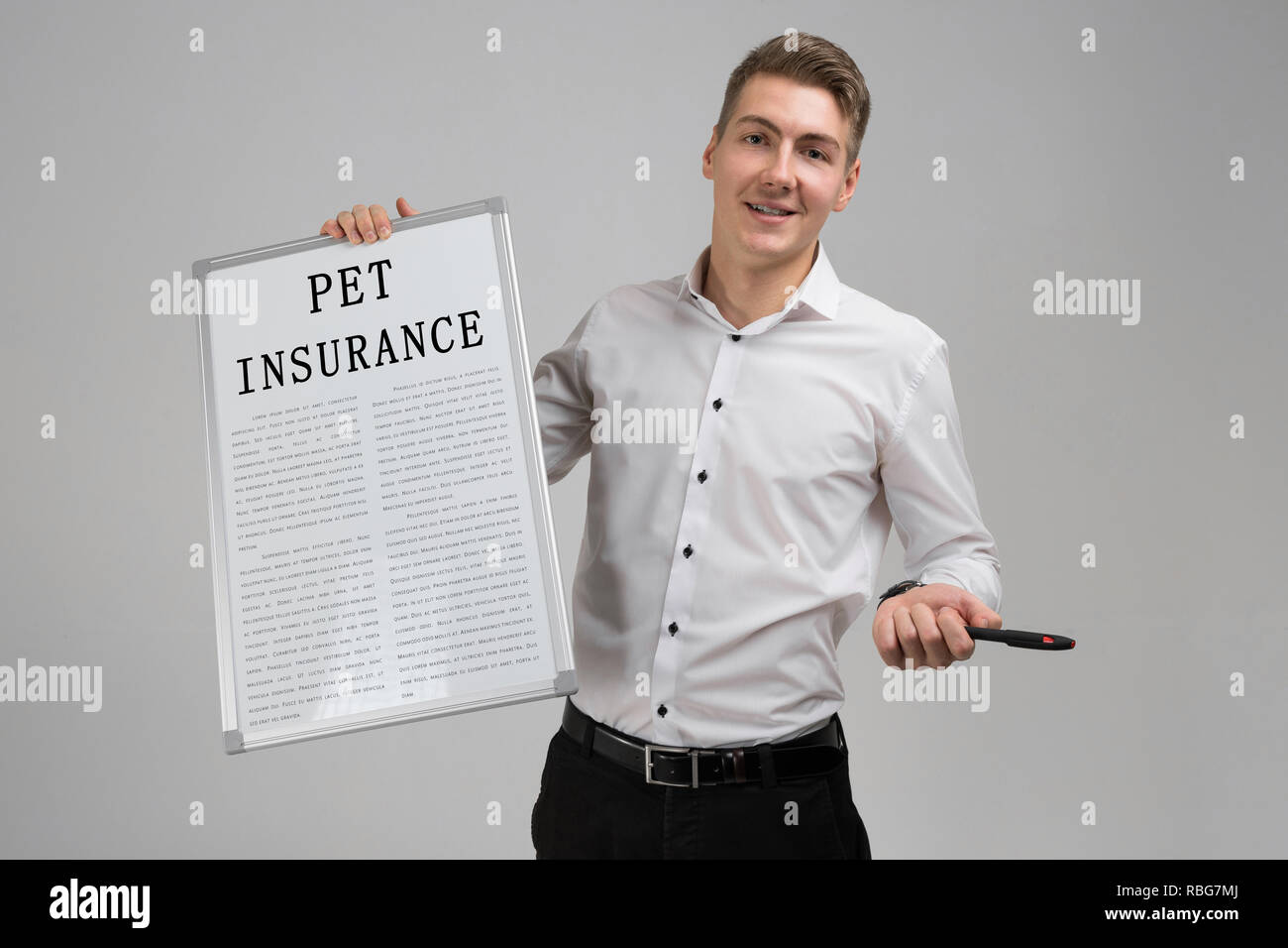 Young man holding poster with pet insurance isolated on light background Stock Photo