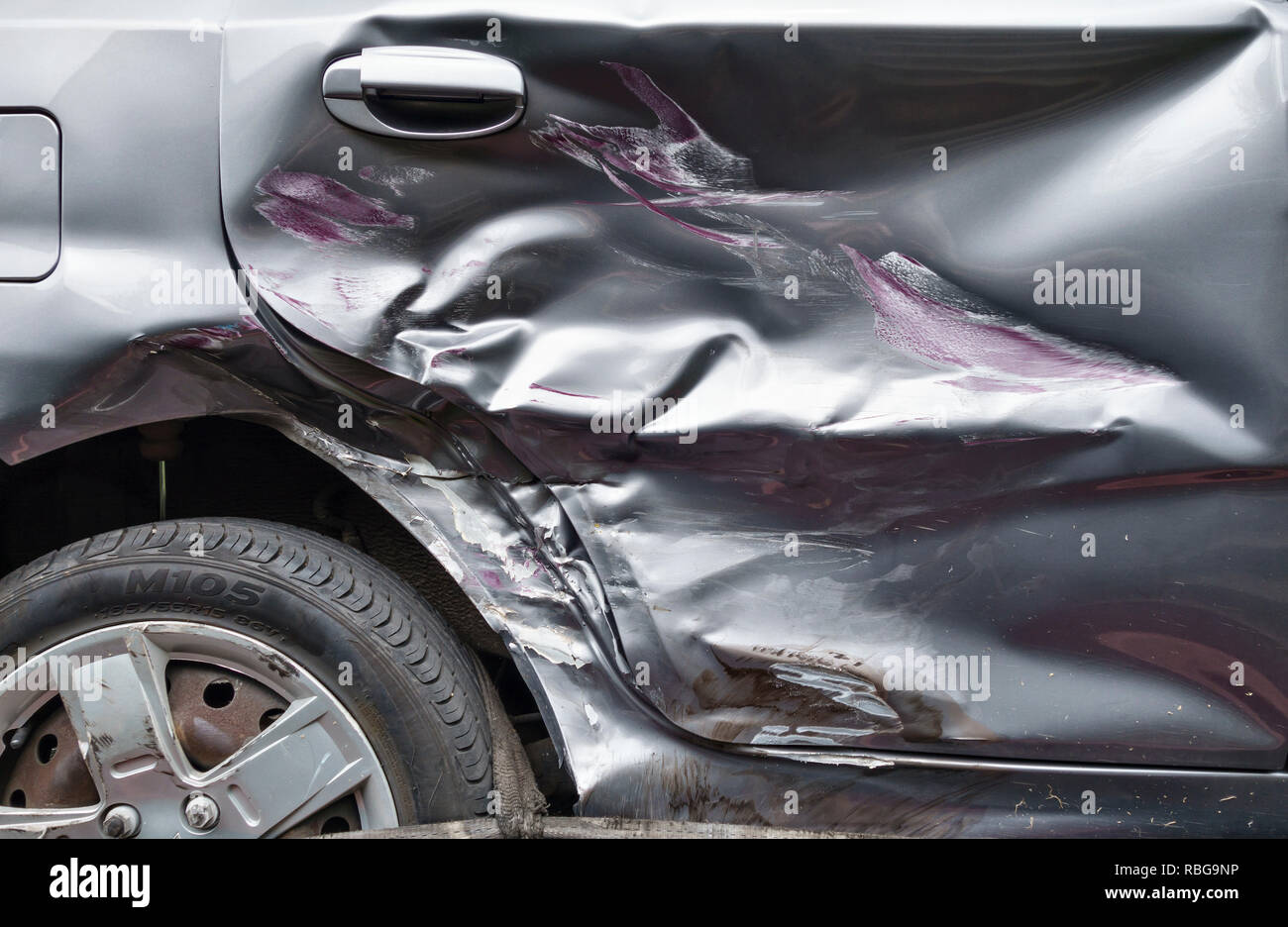 UK. Close up of a car door, badly damaged in a collision with another vehicle Stock Photo