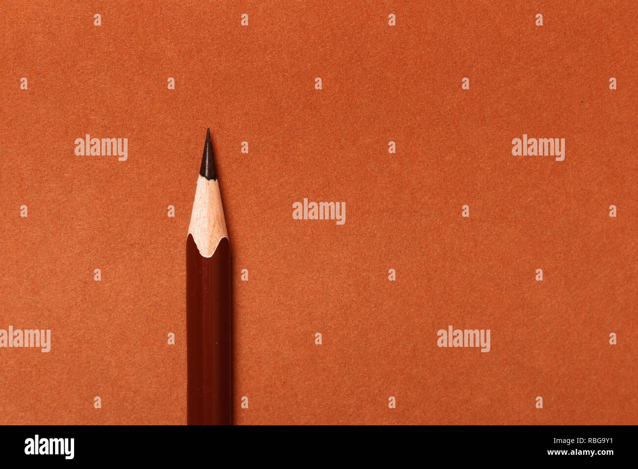Brown pencil on a brown paper background Stock Photo - Alamy