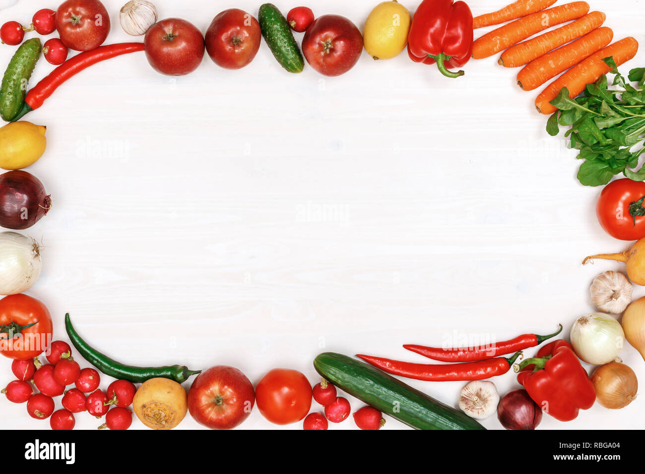 Vegetables and fruits on a white wooden table. Top view. Copy space ...