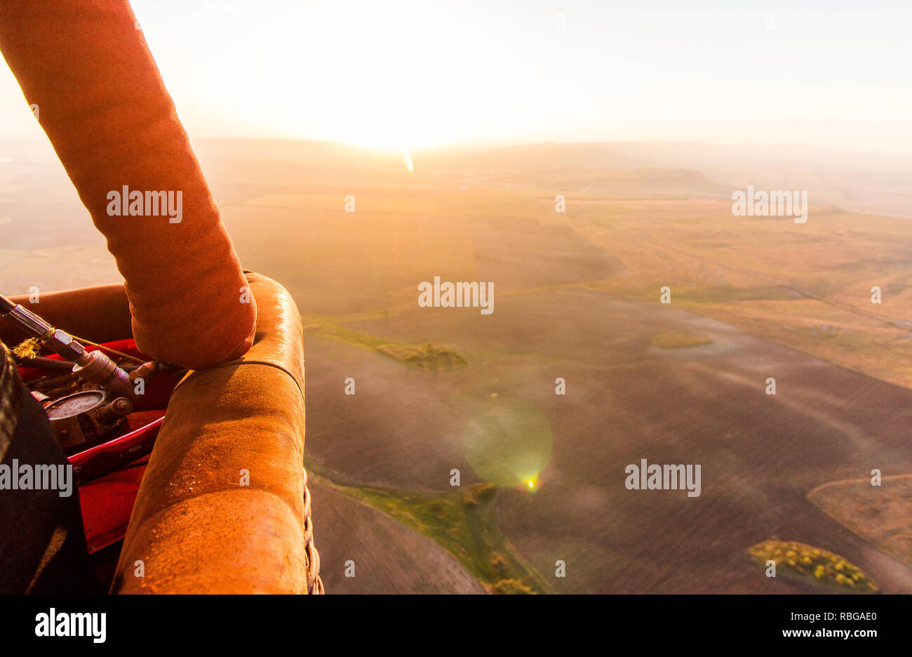 Hot air balloon busket during sunrise flying over the valley Stock ...