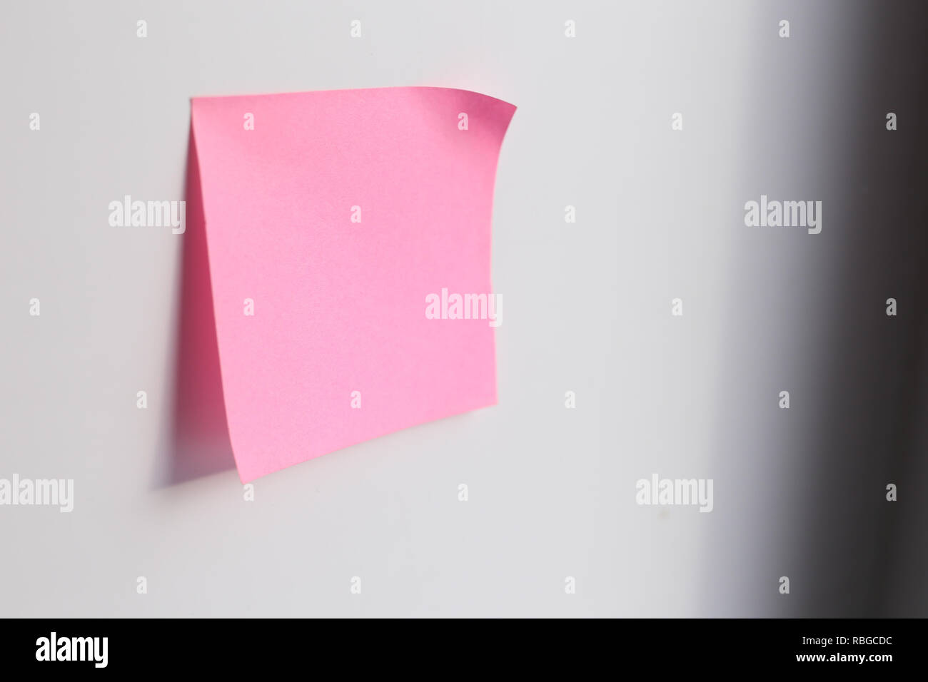 Pink sticky note with copy space on blue background Stock Photo