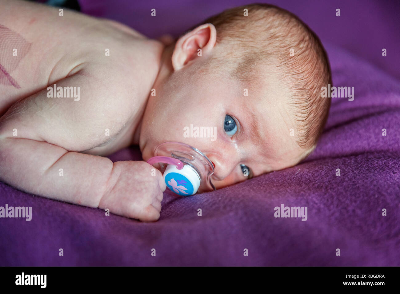 Soft Portrait Of Peaceful Sweet Newborn Infant Baby Lying On Bed