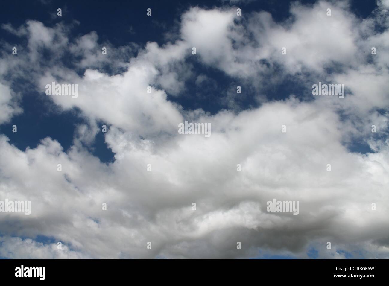 Fluffy white clouds in a blue summer sky Stock Photo - Alamy