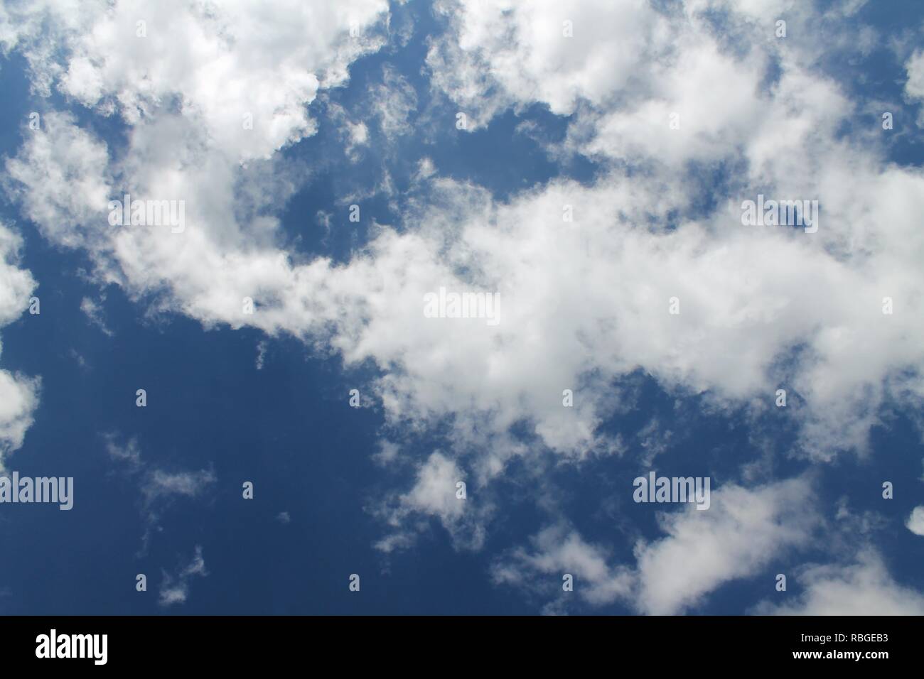 Fluffy white clouds in a blue summer sky Stock Photo - Alamy