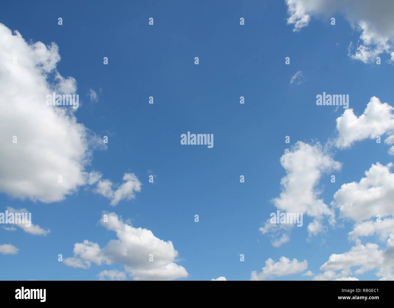 Fluffy white clouds in a blue summer sky Stock Photo - Alamy
