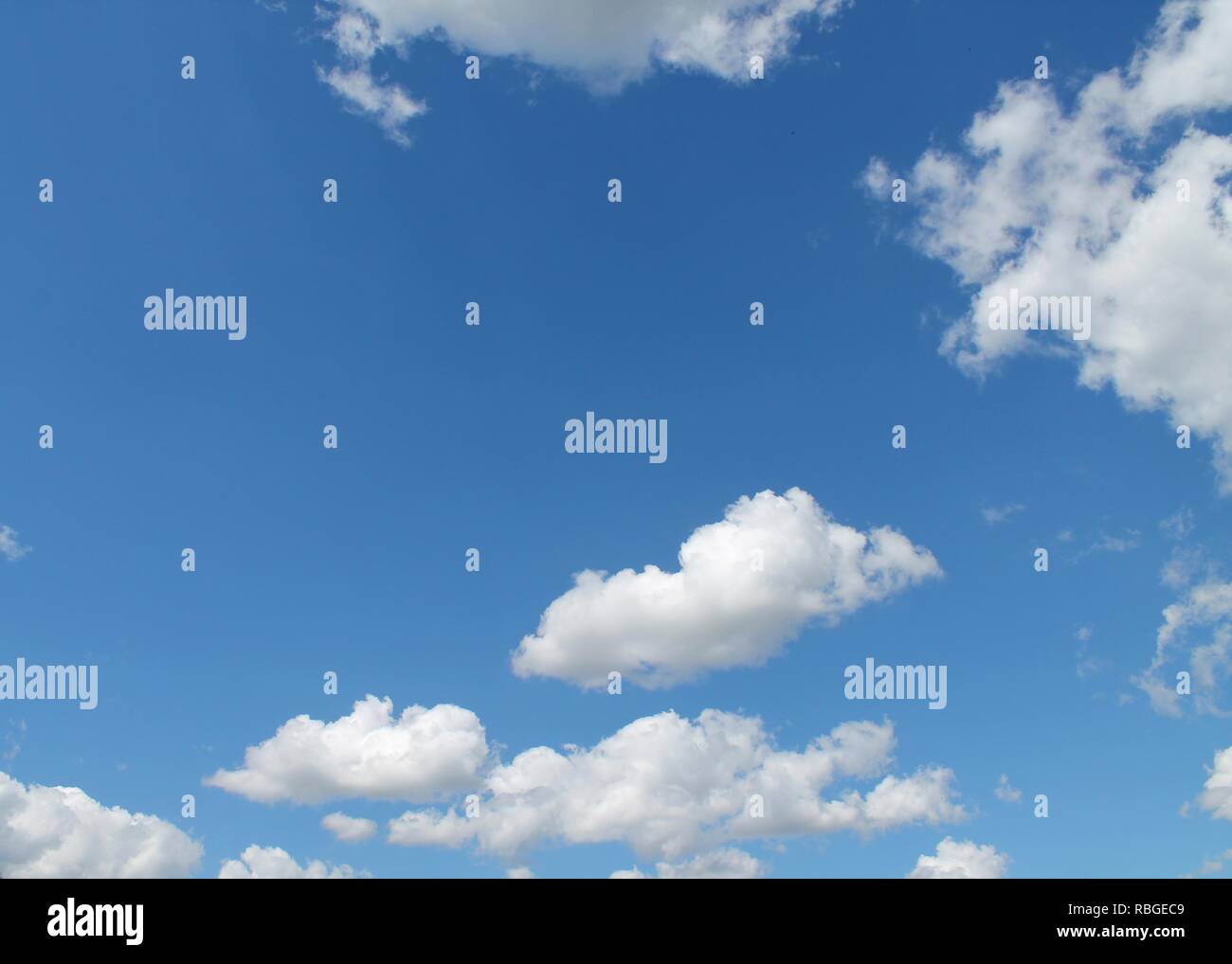 Fluffy white clouds in a blue summer sky Stock Photo - Alamy