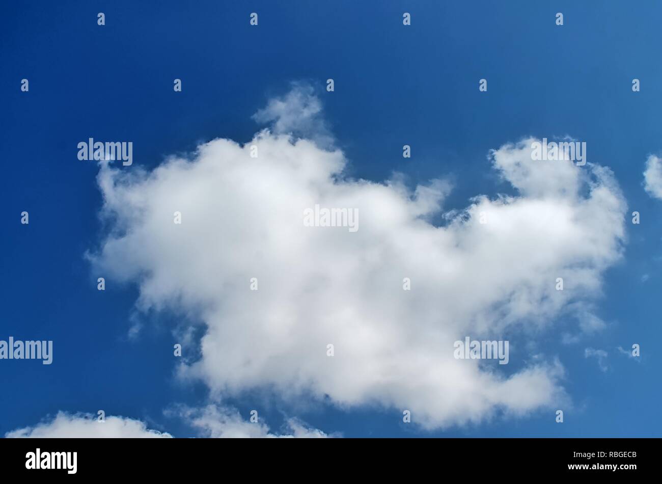 Fluffy white clouds in a blue summer sky Stock Photo - Alamy