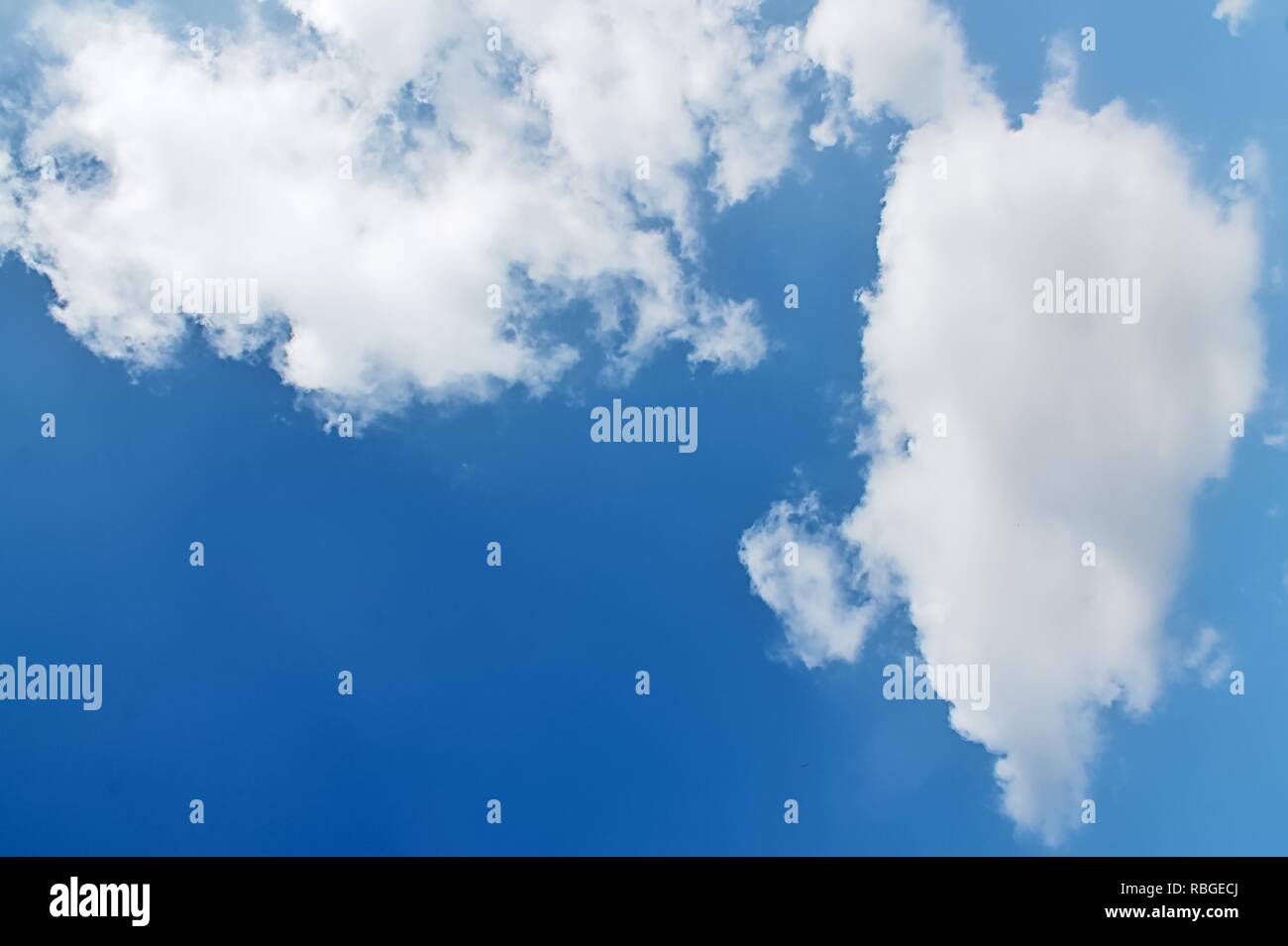 Fluffy white clouds in a blue summer sky Stock Photo - Alamy