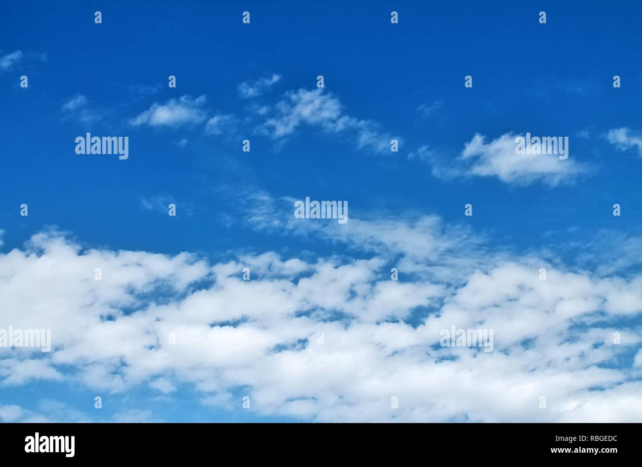 Fluffy white clouds in a blue summer sky Stock Photo - Alamy