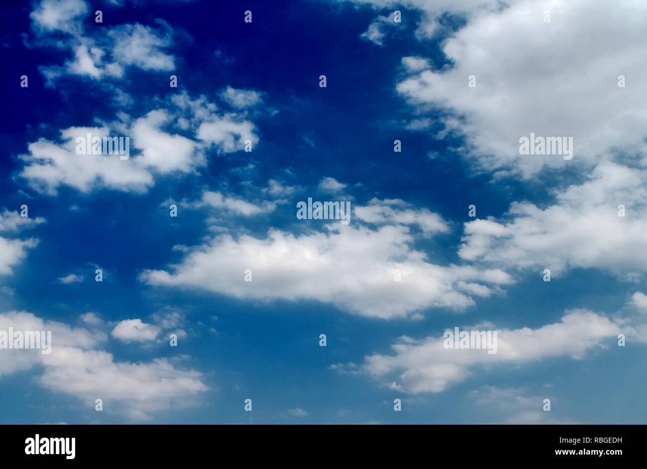 Fluffy white clouds in a blue summer sky Stock Photo - Alamy