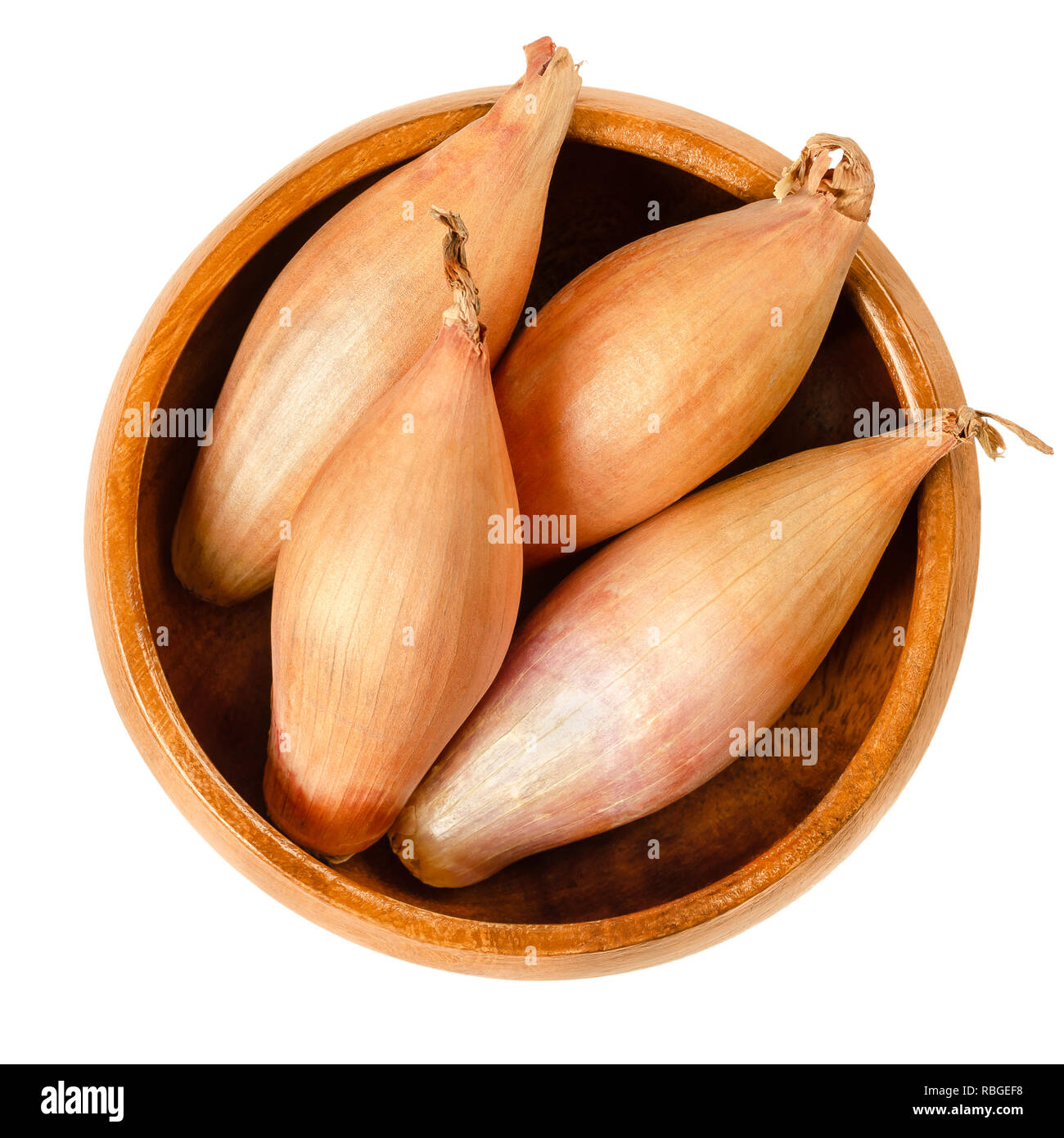 Whole long shallots in wooden bowl. Type of onion, Longor, French variety of Allium cepa with mild flavor. Brown, edible, raw, organic and vegan plant Stock Photo
