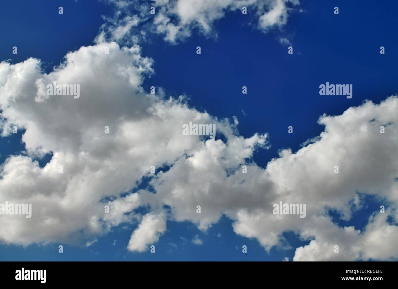 Fluffy white clouds in a blue summer sky Stock Photo - Alamy