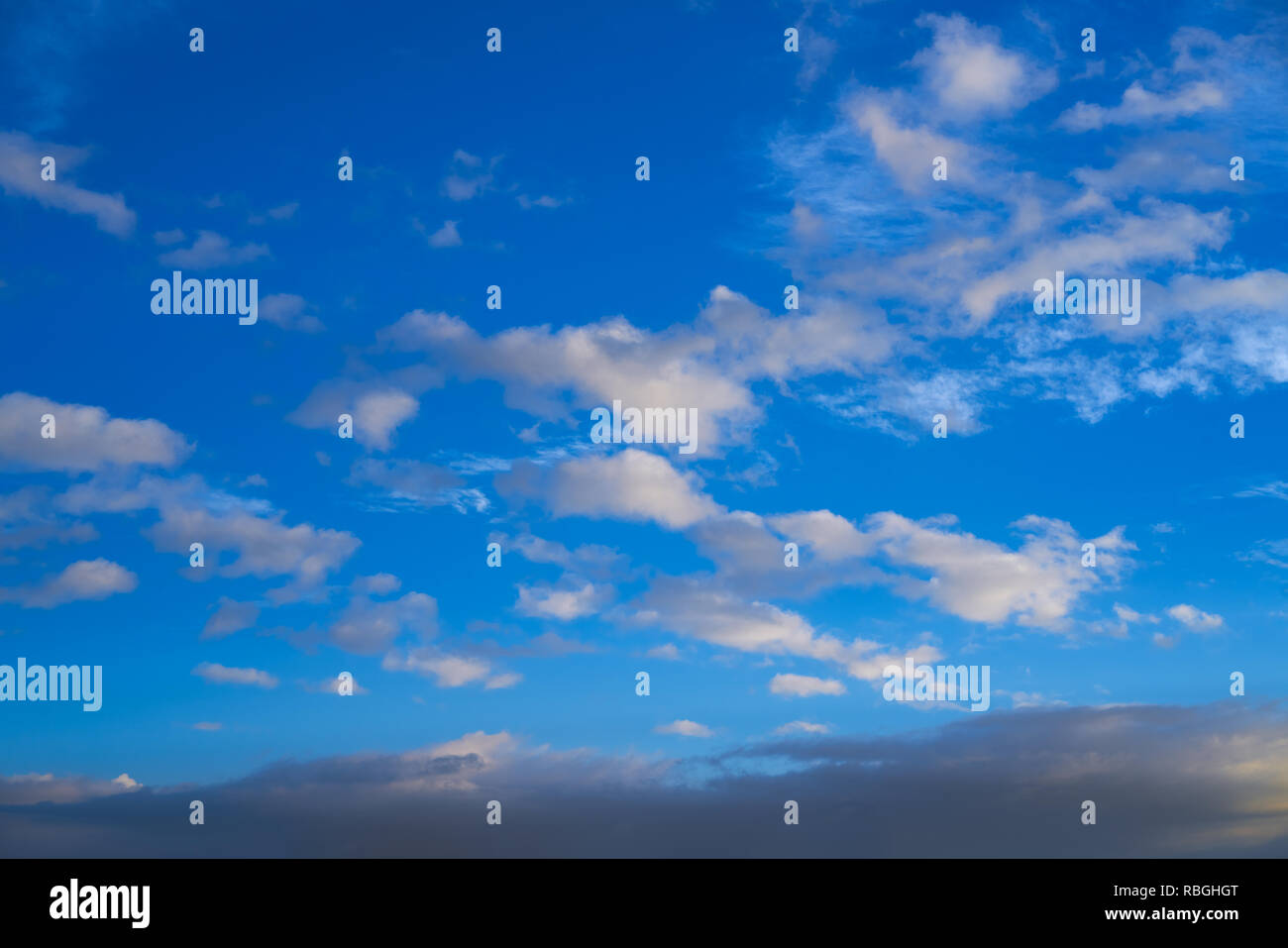Blue sky at sunset background with clouds Stock Photo
