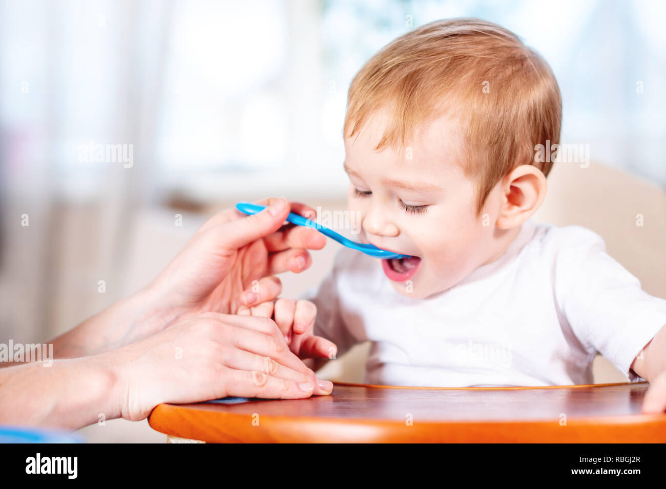 baby holding spoon