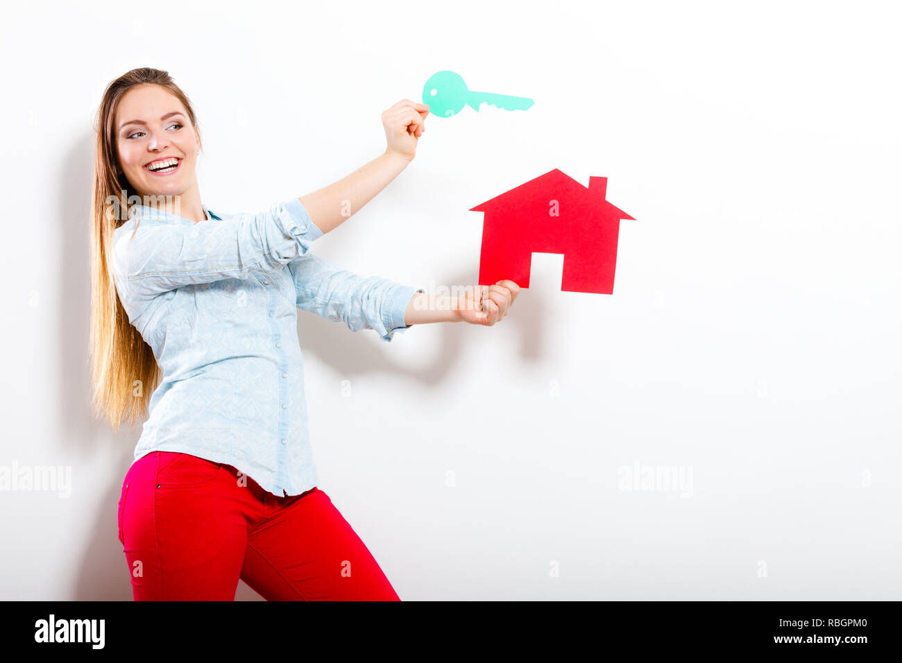 Happy woman girl holding paper house and key dreaming about new home ...