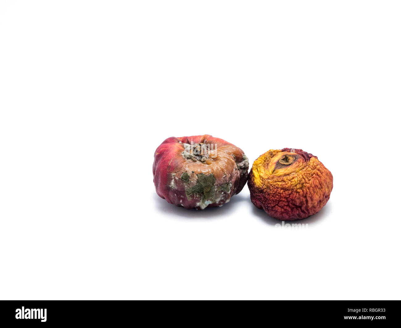 Two rotten fruits isolated on white background. Stock Photo