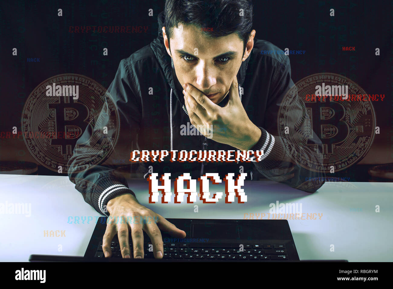 A hacker with a face is trying to steal cryptocurrency using a computer. Scam at Cryptojacking Stock Photo