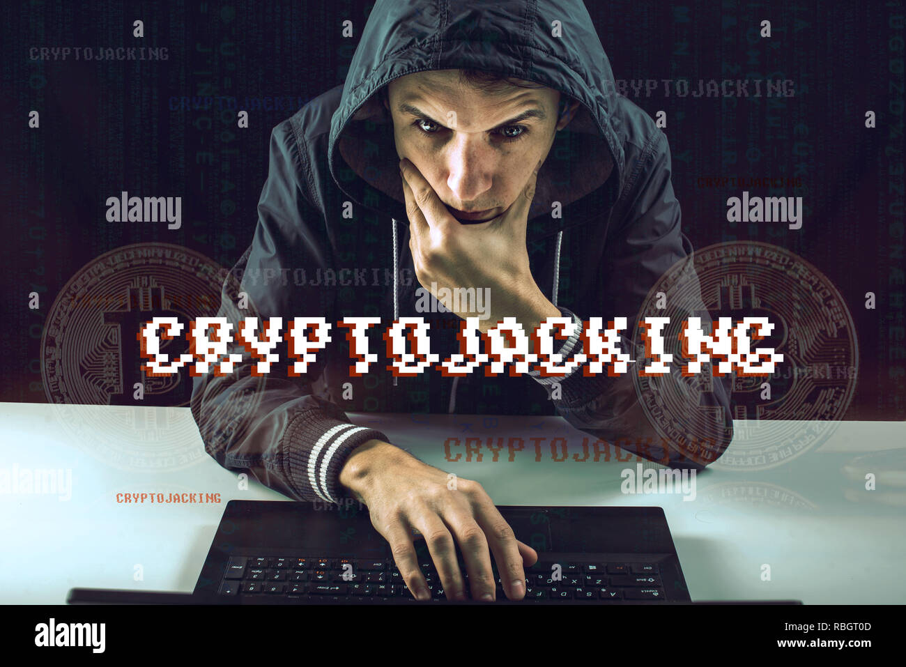 A hacker with a face is trying to steal cryptocurrency using a computer. Scam at Cryptojacking Stock Photo