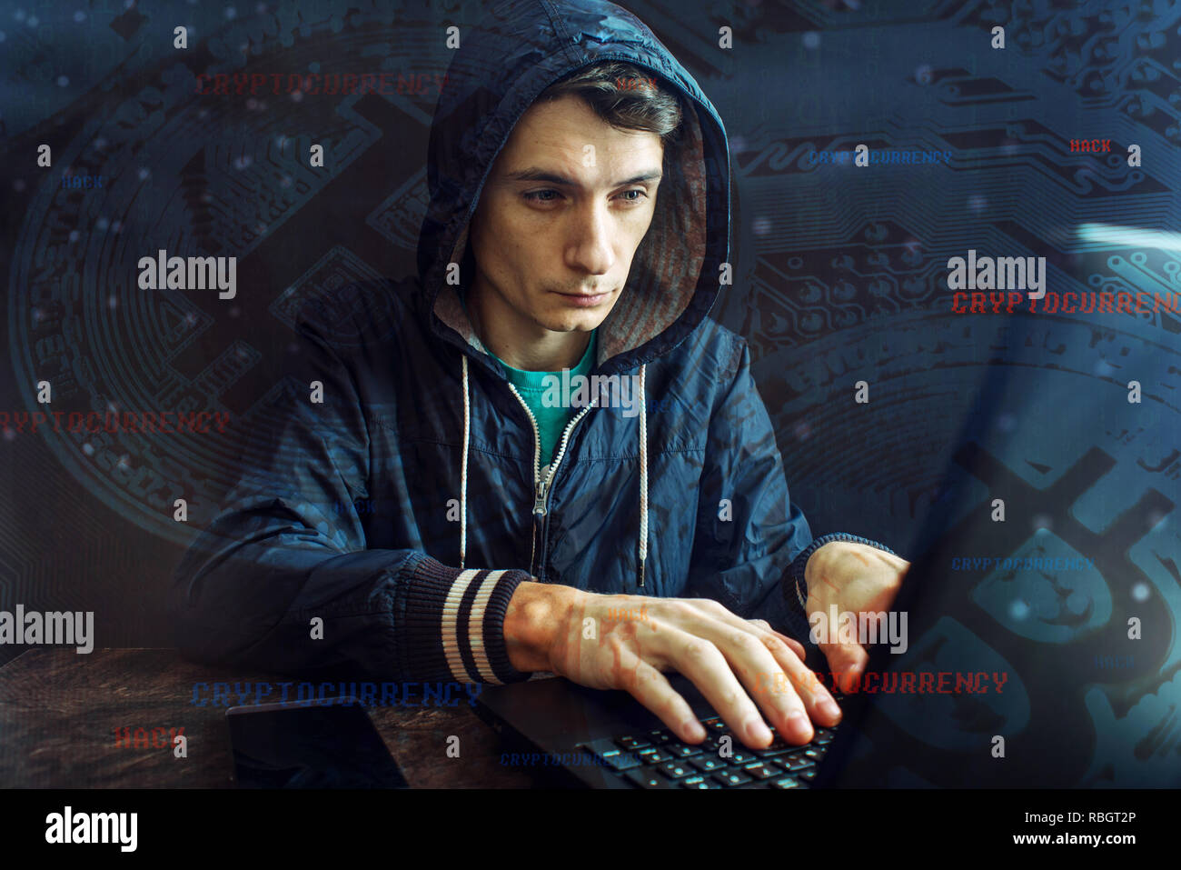 A hacker with a face is trying to steal cryptocurrency using a computer. Fraud and deception at Cryptojacking Stock Photo