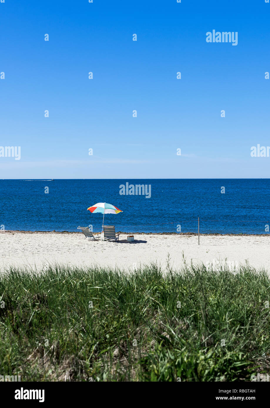 Beach umbrella and chairs, West Dennis Beach, Cape Cod, Massachusetts, USA. Stock Photo