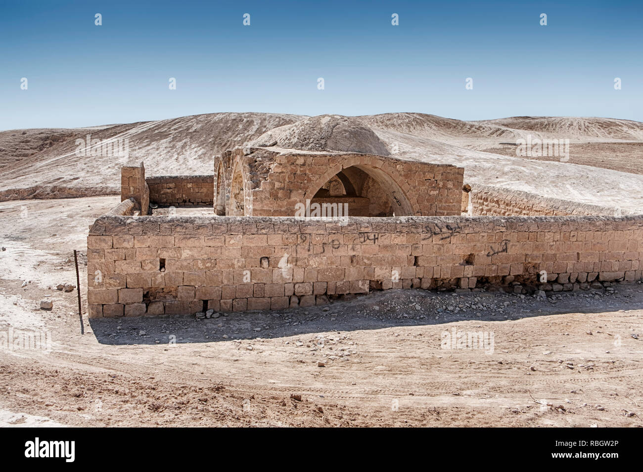 A tomb with a surrounding wall made of stone stands in the middle of the Negev Desert In Israel. Stock Photo