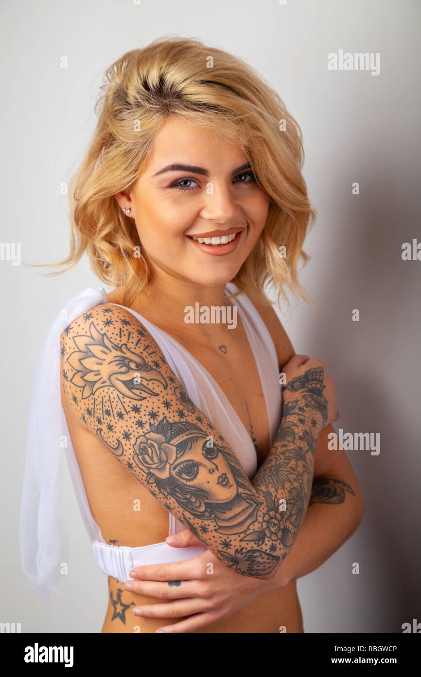 AI Generated Beauty Portrait of pretty girl with short hair and cool tattoos,  looking into a camera. 33479465 Stock Photo at Vecteezy