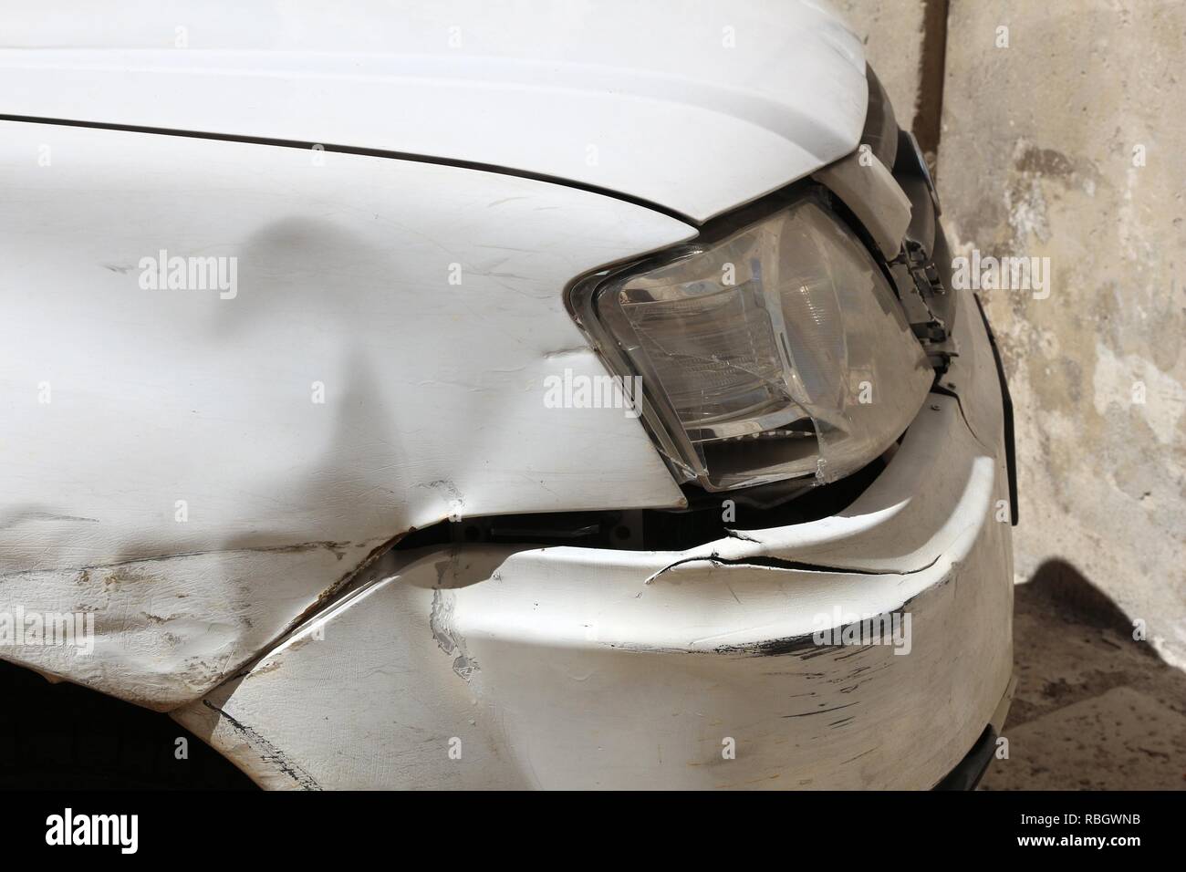 Generic car with scratched and dented front wing. Minor accident result