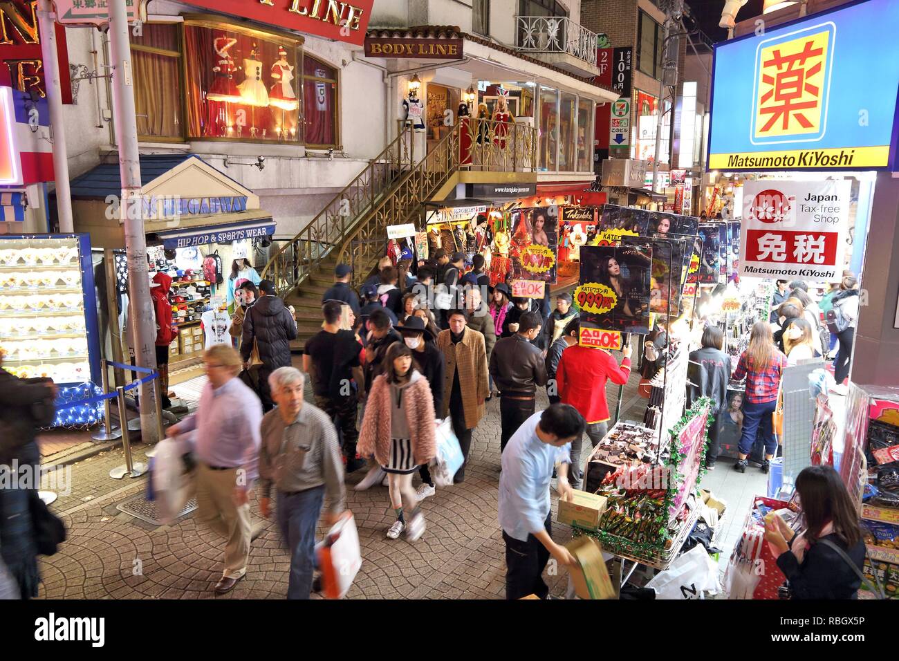 TOKYO, JAPAN - DECEMBER 4, 2016: People visit night Harajuku district of Tokyo, Japan. Tokyo is the capital city of Japan. 37.8 million people live in Stock Photo