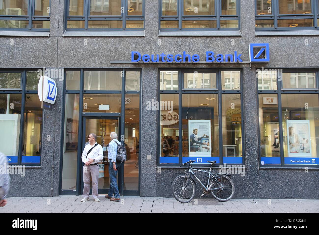 HAMBURG, GERMANY - AUGUST 28, 2014: People visit Deutsche Bank branch in Hamburg. Deutsche Bank is one of largest banks in the world with 98,200 emplo Stock Photo