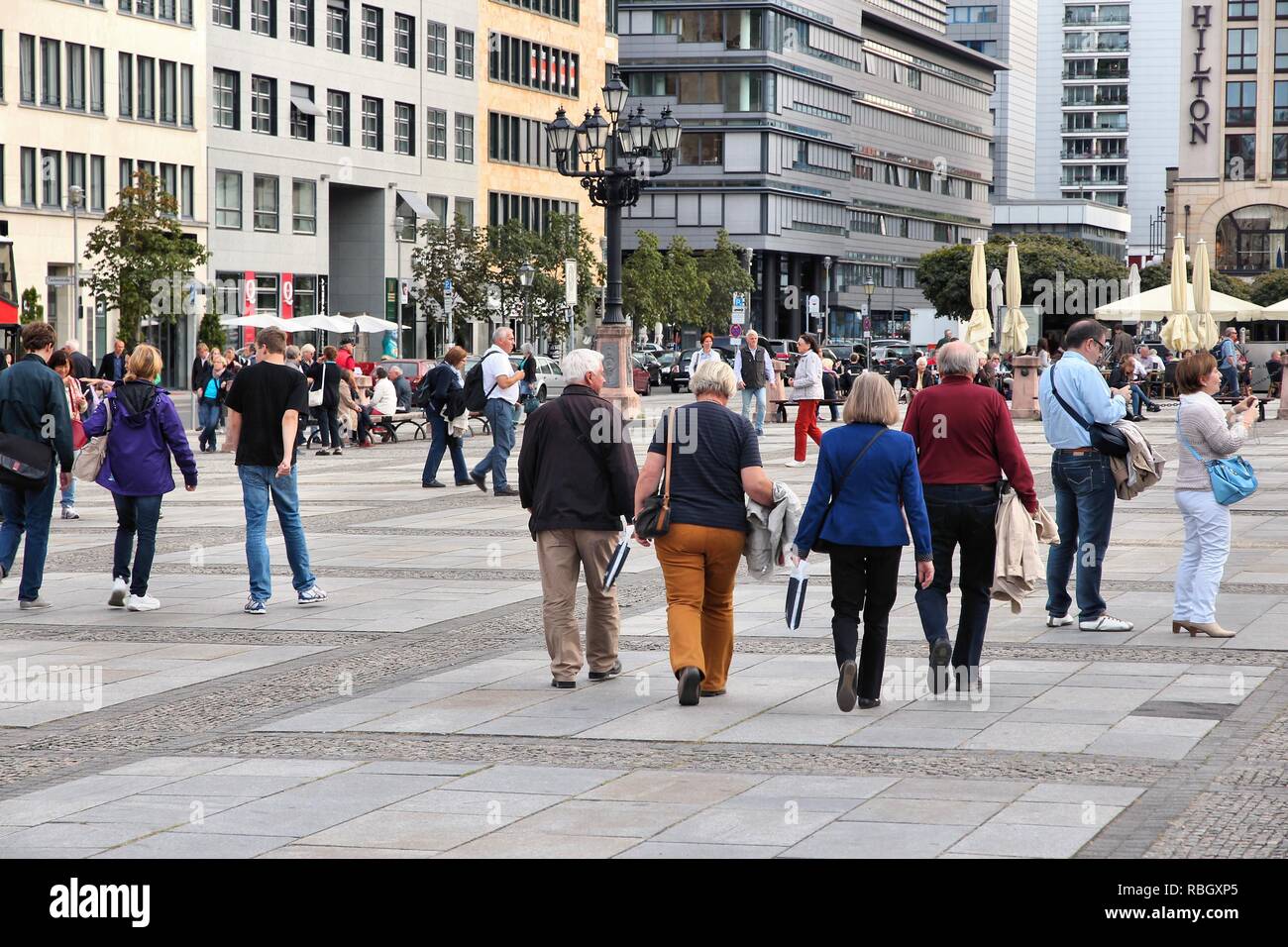 BERLIN, GERMANY - AUGUST 26, 2014: People visit Gendarmenmarkt square in Berlin. Berlin is Germany's largest city with population of 3.5 million. Stock Photo
