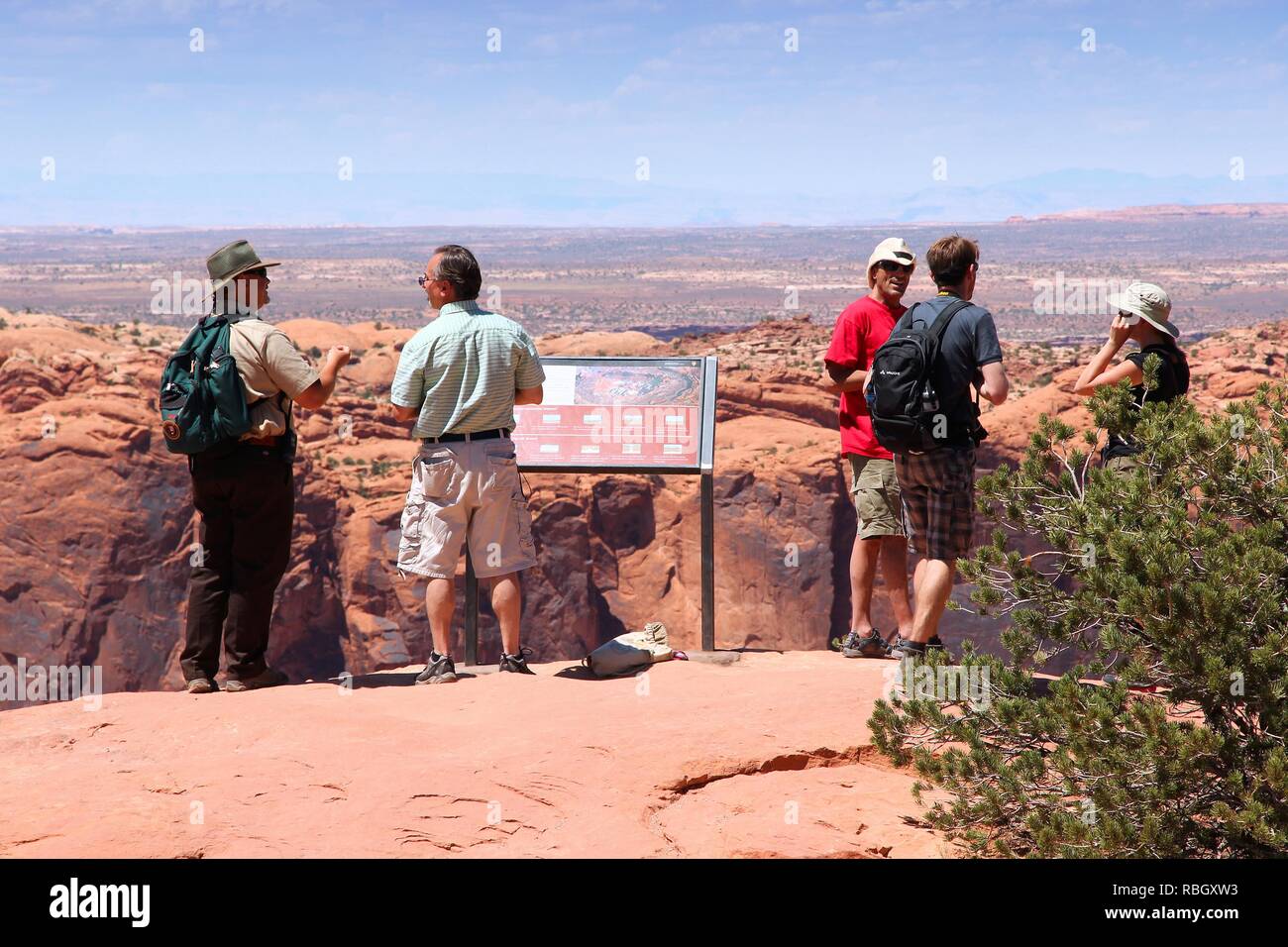 CANYONLANDS, UNITED STATES - JUNE 22, 2013: People admire landscape in Canyonlands National Park, USA. More than 452,000 people visited Canyonlands NP Stock Photo