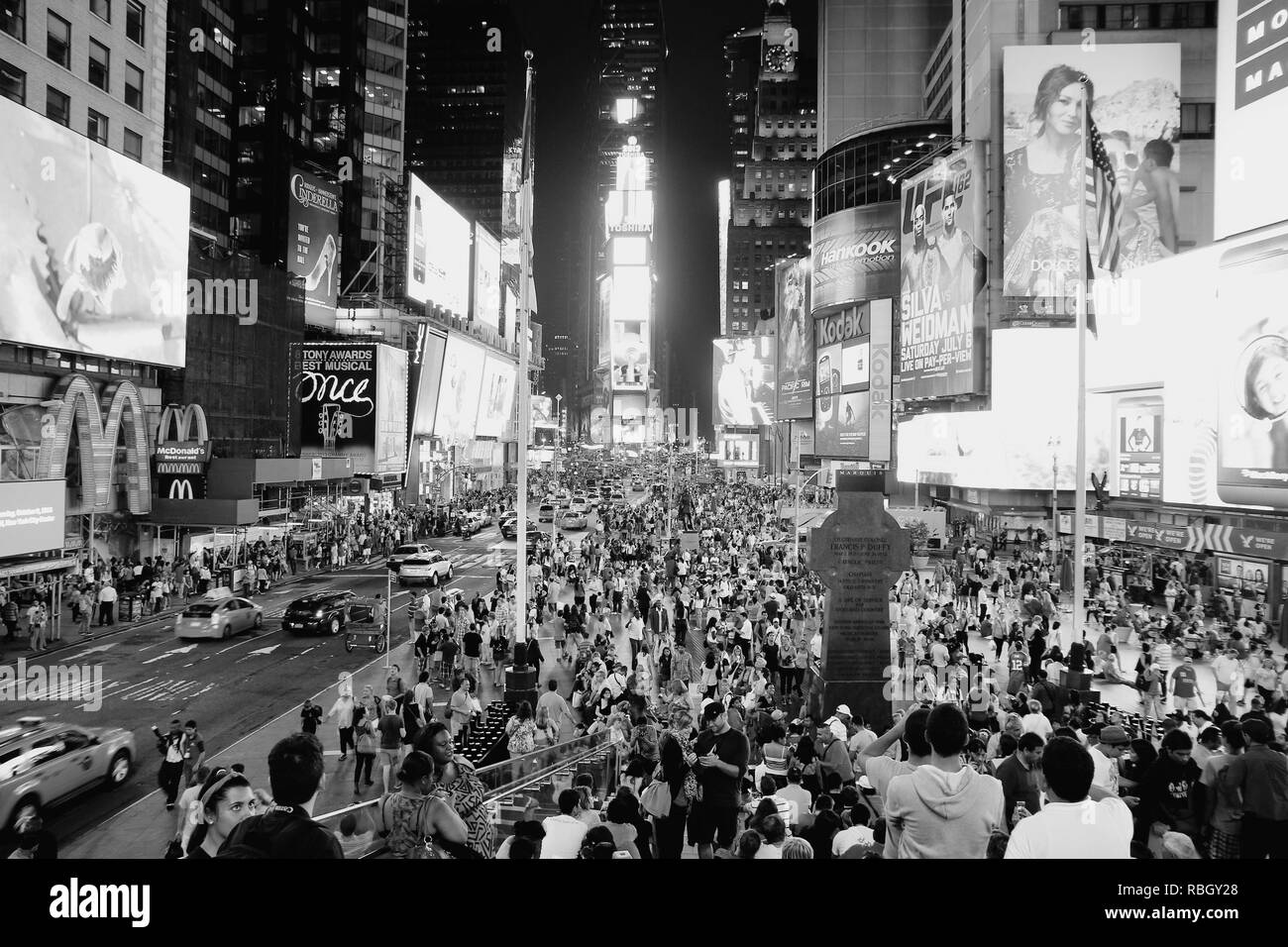 NEW YORK, USA - JULY 1, 2013: People walk in Times Square in New York. Times Square is one of most recognized landmarks in the world. More than 300,00 Stock Photo