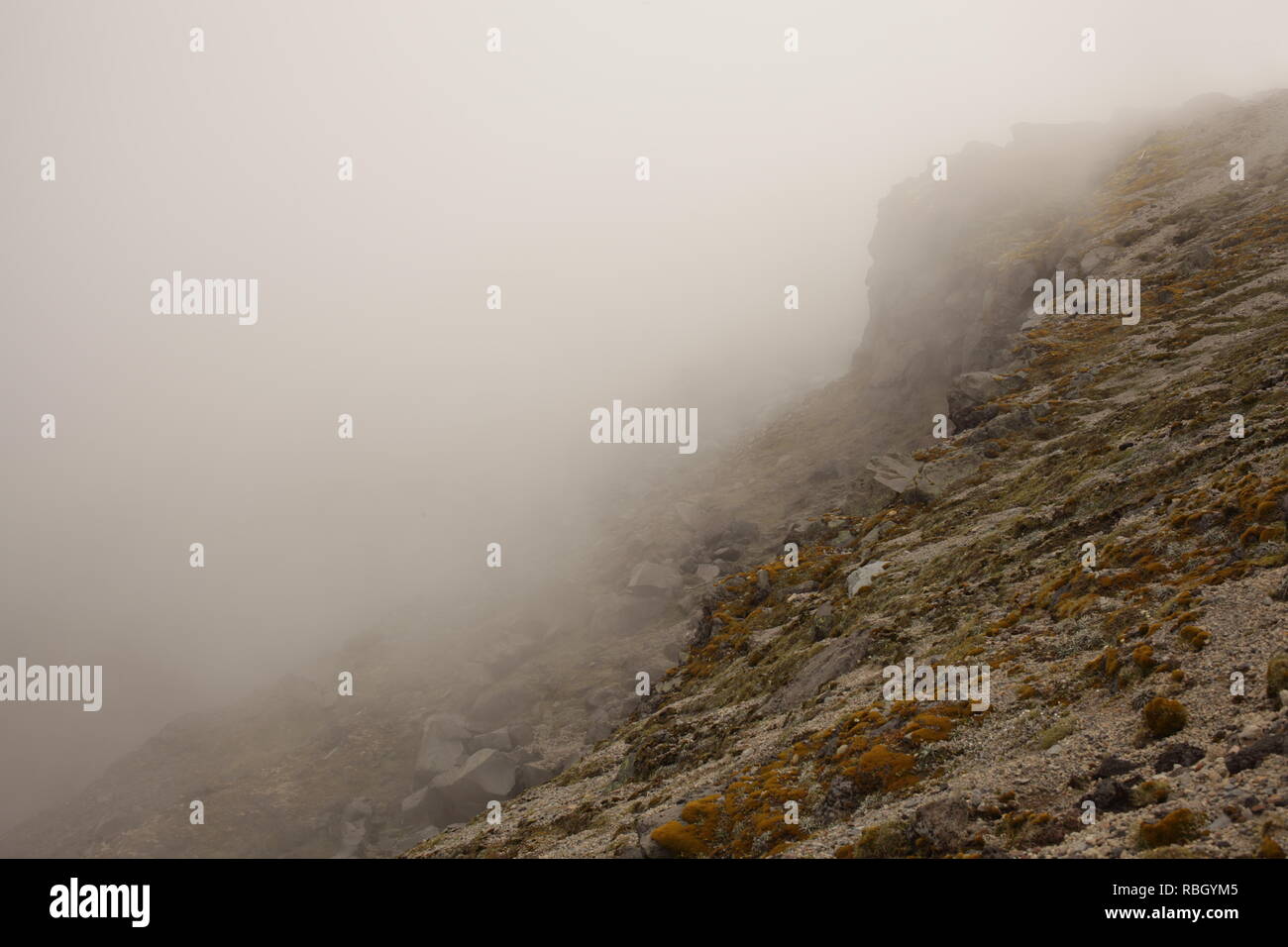Rocky slopes in mountain mist Stock Photo