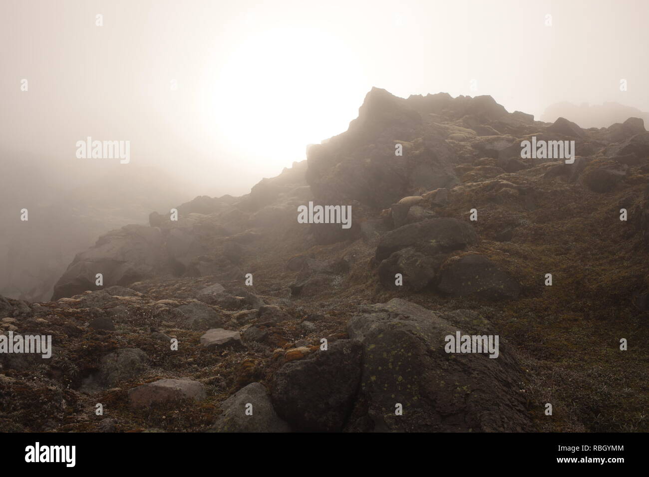 Rocky slopes in mountain mist Stock Photo
