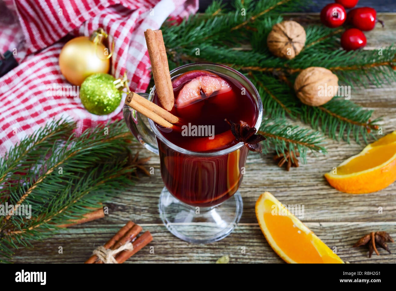 https://c8.alamy.com/comp/RBH2G1/hot-mulled-wine-in-glass-mug-on-a-wooden-table-fragrant-traditional-winter-drink-based-on-wine-juice-spices-seasonings-fruits-RBH2G1.jpg