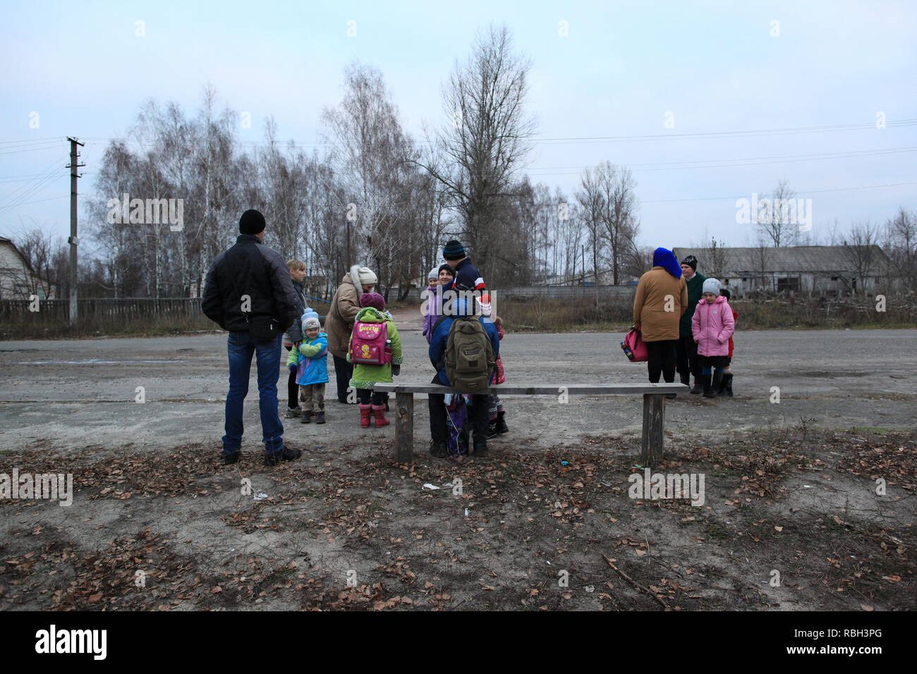 In the early morning villagers are waiting with their children at the bus stop for the school bus. Radinka, Polesskiy district, northern Ukraine Stock Photo