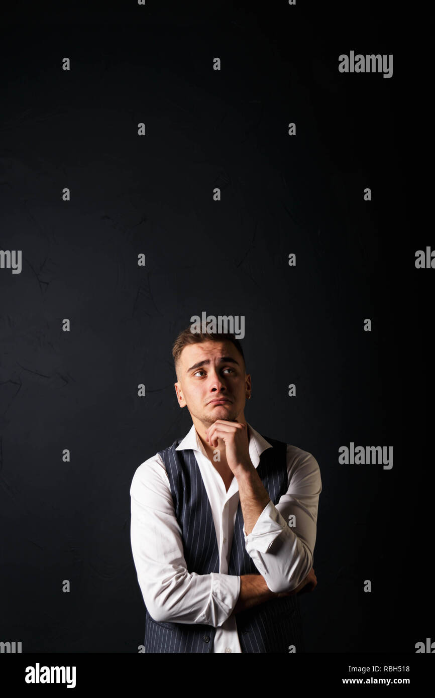 Portrait of young handsome man wearing white shirt standing on the gray ...