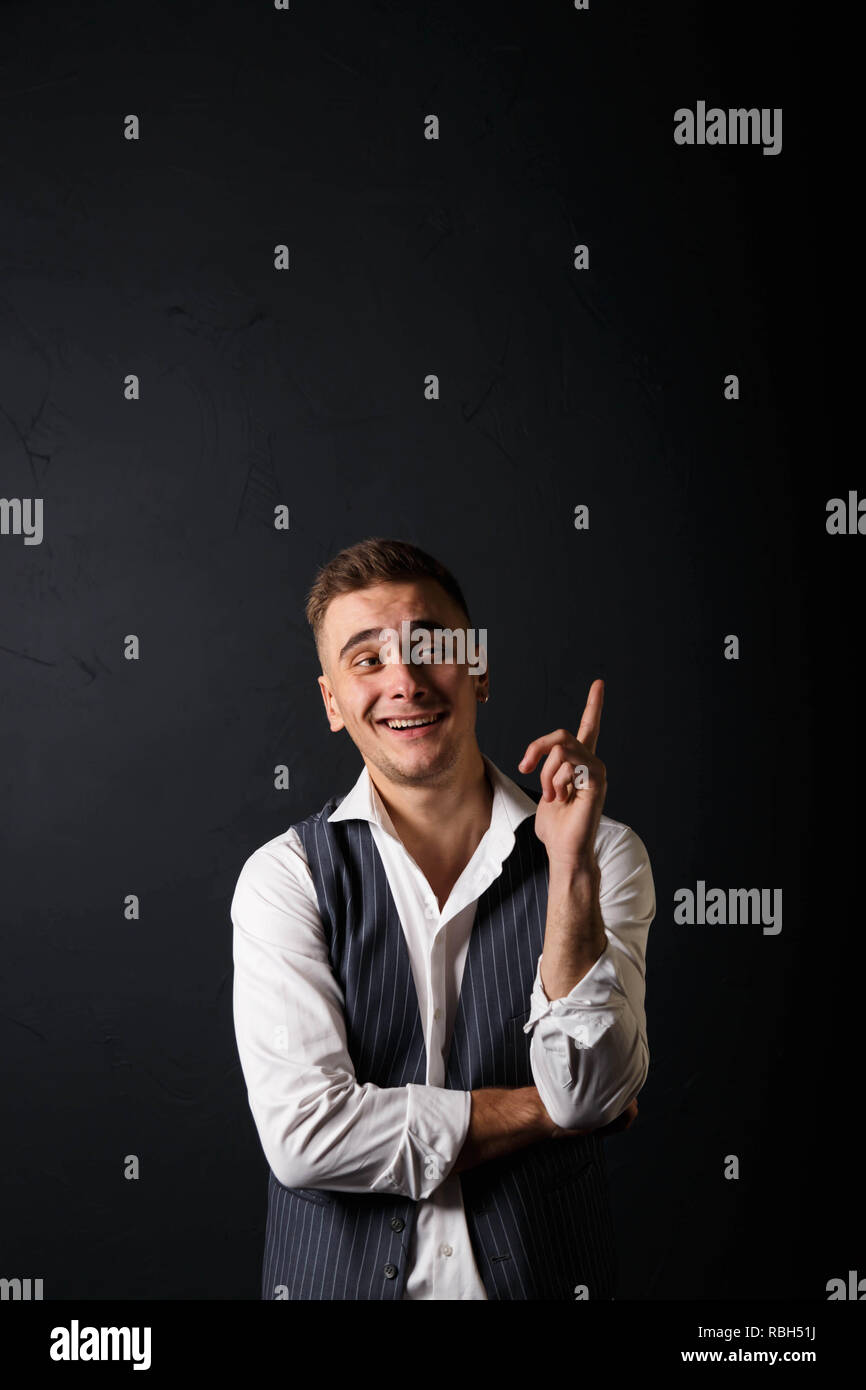 Portrait of young handsome man wearing white shirt standing on the gray ...