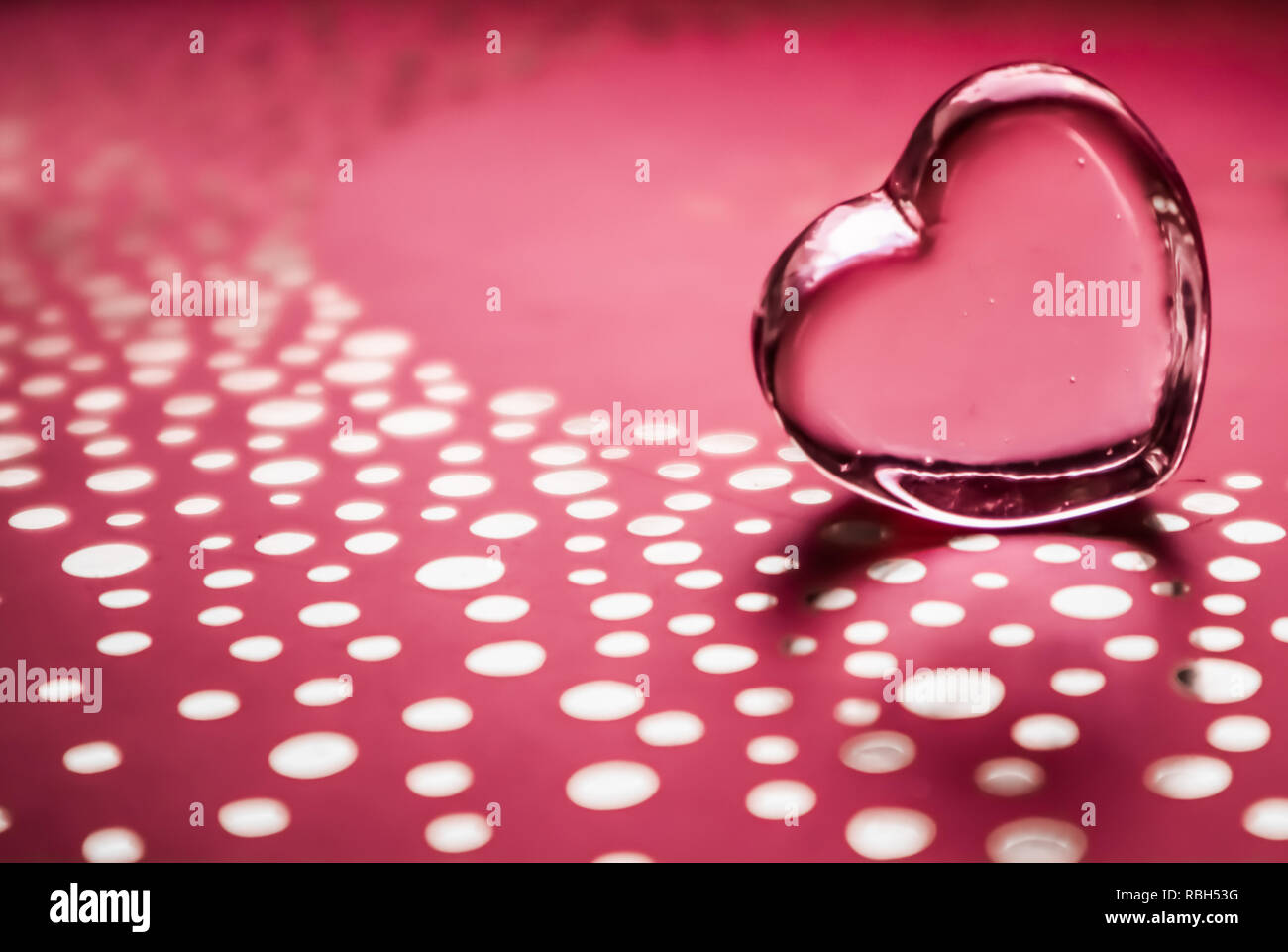 Shining transparent heart. Perfect Valentine's Day greeting card background. Horizontal image in pink tone Stock Photo