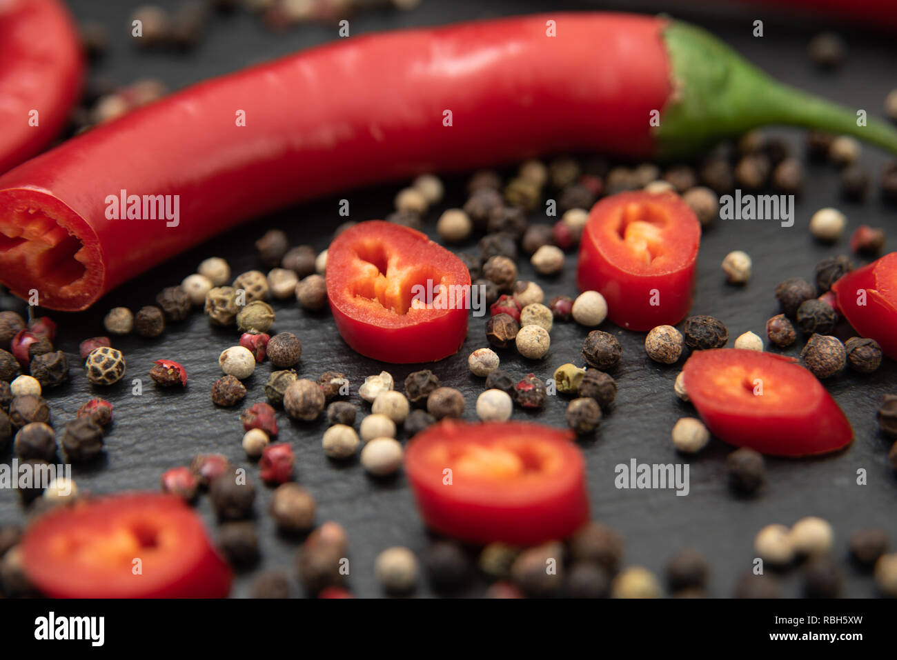 Red hot chili pepper cut into slices. With mixed peppercorns Stock Photo Alamy