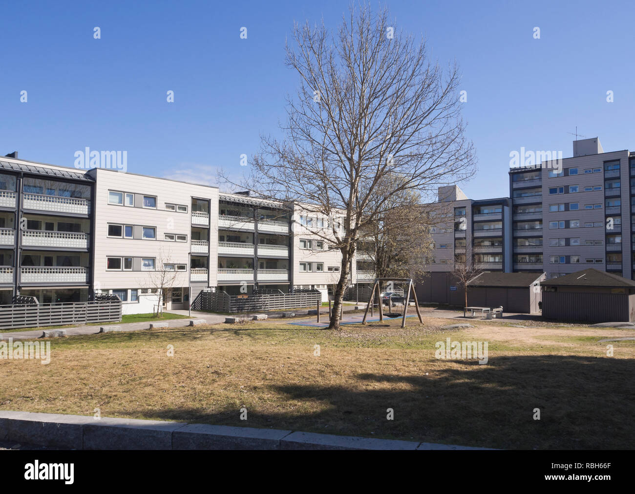 Green spaces and playgrounds between apartment blocks give friendly appearances to a residential neighborhood in the Furuset suburb in Oslo Norway Stock Photo