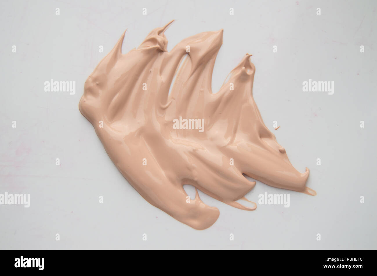Concealer, light beige makeup, smear cream base, Foundation on white background Stock Photo Alamy