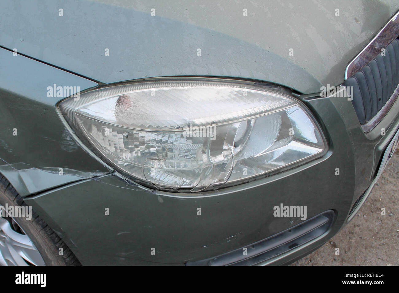 Car Crash; Body work and headlight damage after a vehicle / auto crash. Stock Photo