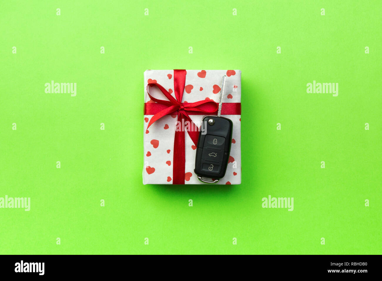 Give gift car key concept top view. Present box with red ribbon bow ...