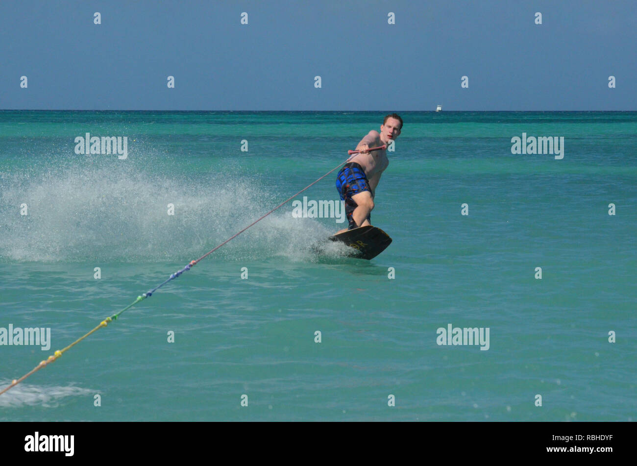 Young guy wakeboarding and leaning into a turn Stock Photo Alamy
