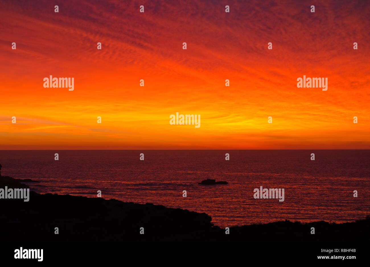 Bright orange sunrise in the algarve Stock Photo