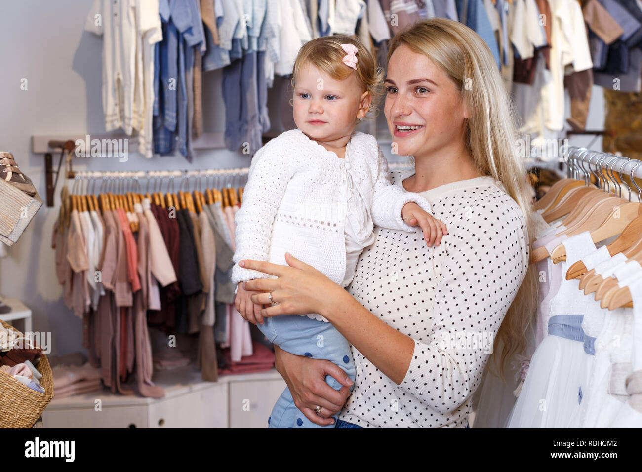Young Mother Holding Little Daughter In Her Arms In Baby Clothing Store Stock Photo Alamy