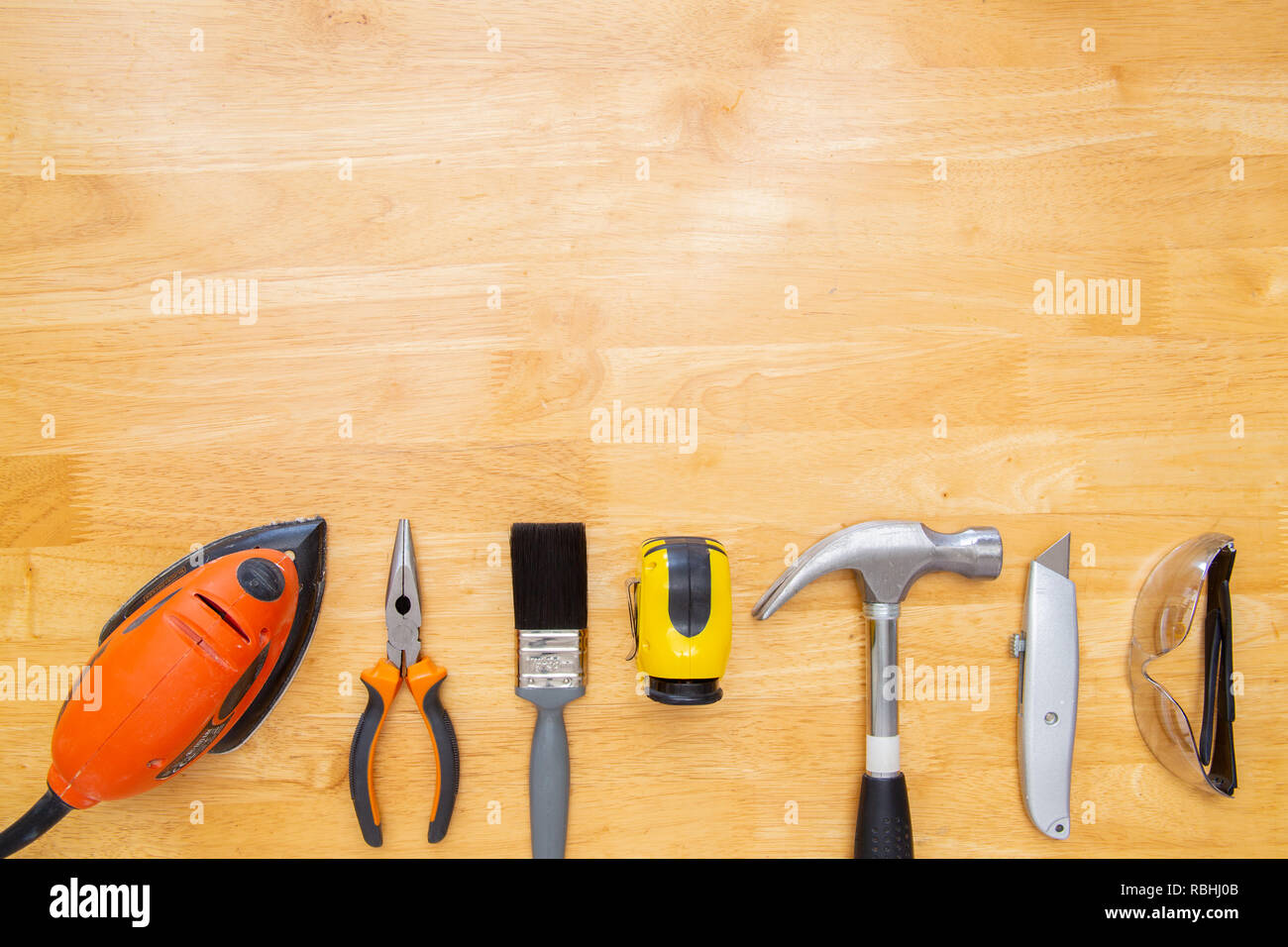Various household tools sit on a kitchen table top, with space for copy. Stock Photo