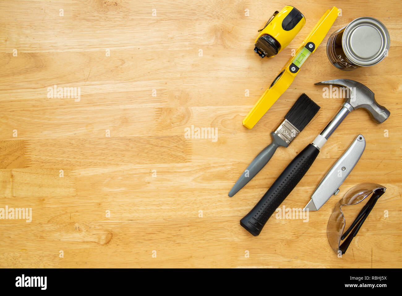 Various household tools sit on a kitchen table top, with space for copy. Stock Photo